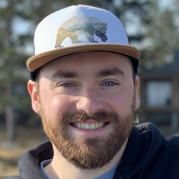 Andrew smiling in the woods